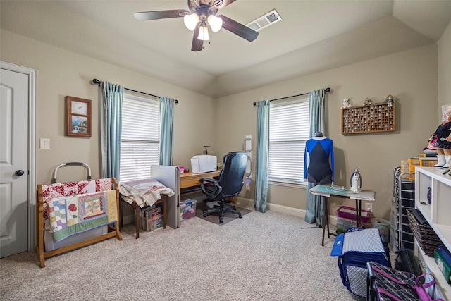 carpeted office with ceiling fan and a healthy amount of sunlight