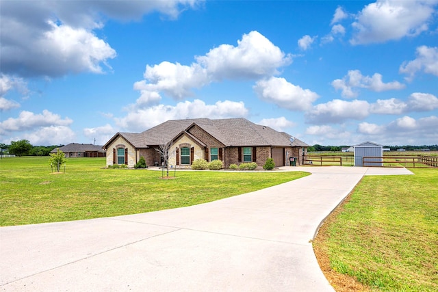 view of front of property with a garage, an outdoor structure, and a front lawn