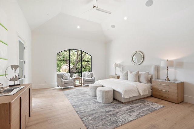 bedroom featuring high vaulted ceiling, ceiling fan, and light wood-type flooring