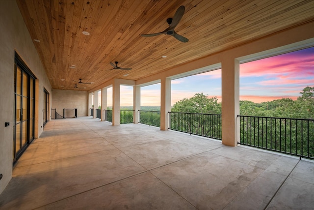 unfurnished sunroom featuring wooden ceiling and ceiling fan