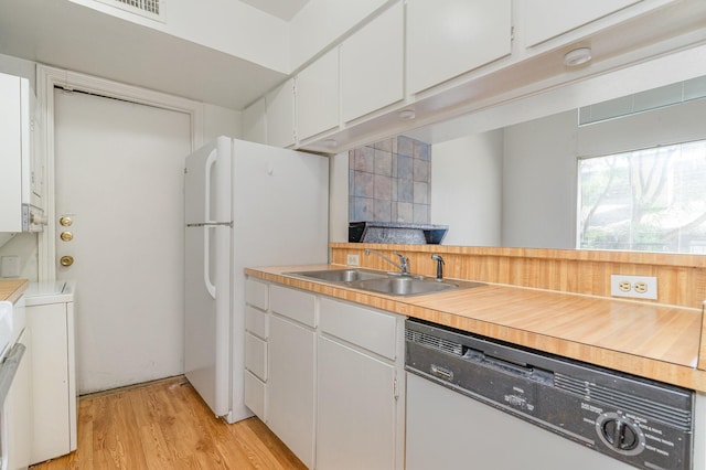 kitchen with separate washer and dryer, dishwashing machine, white cabinetry, white fridge, and sink