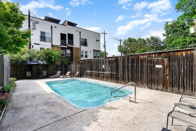 view of swimming pool with a patio