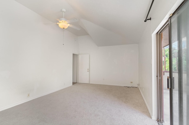 empty room with vaulted ceiling, ceiling fan, and light colored carpet