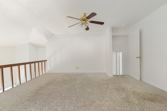 carpeted empty room featuring ceiling fan and vaulted ceiling