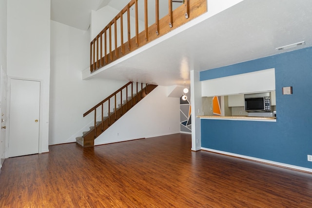 unfurnished living room with dark hardwood / wood-style flooring