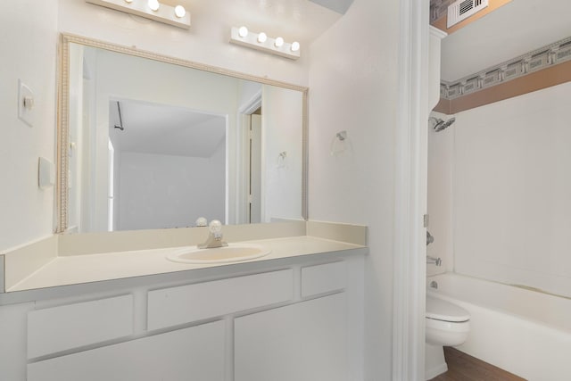 full bathroom featuring toilet, vanity, and shower / washtub combination