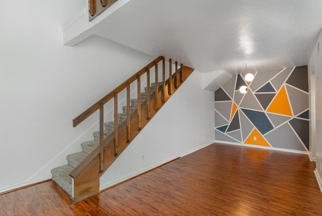 stairs with hardwood / wood-style floors