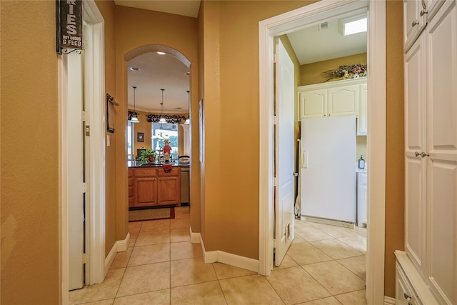 corridor featuring light tile patterned floors