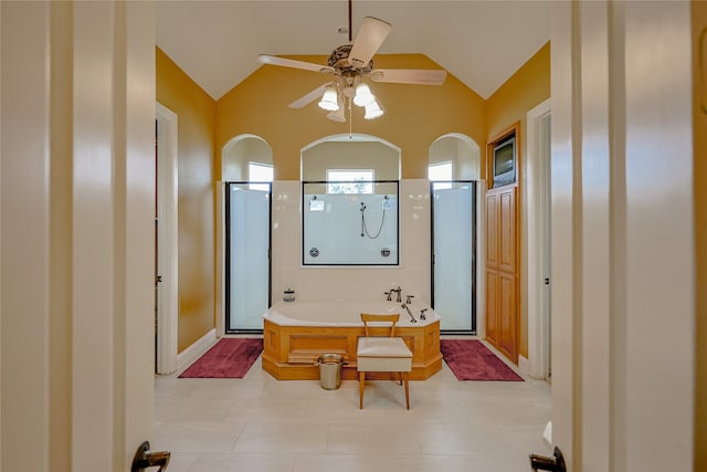 bathroom with ceiling fan, shower with separate bathtub, and vaulted ceiling