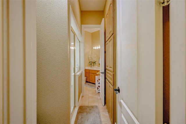 corridor featuring light tile patterned floors