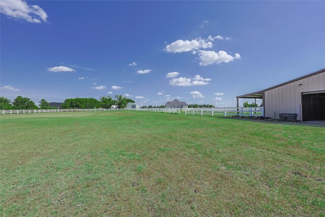 view of yard featuring an outbuilding and a rural view