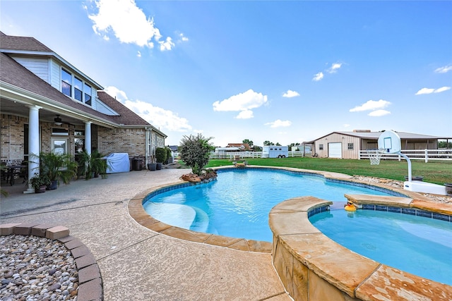 view of pool featuring ceiling fan, a yard, an in ground hot tub, area for grilling, and a patio area