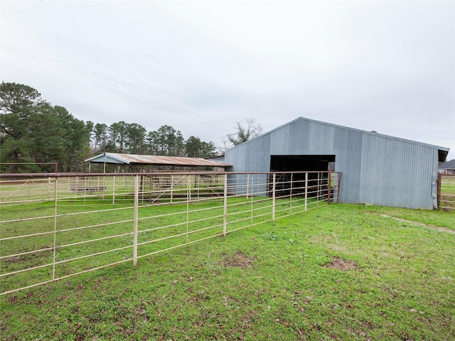 view of outbuilding featuring a yard and a rural view