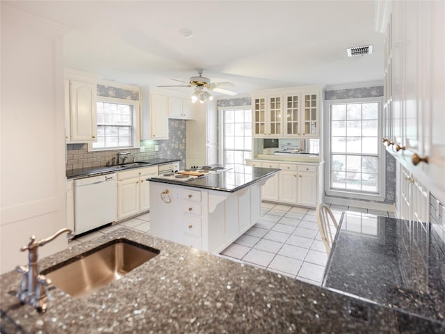 kitchen featuring a center island, white cabinetry, white appliances, and sink