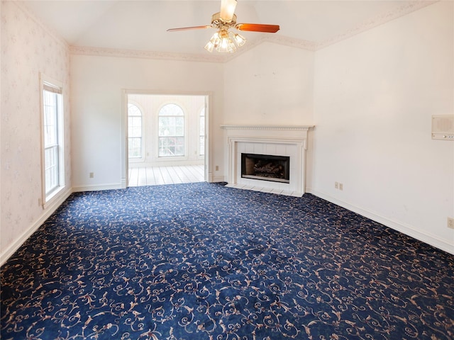 unfurnished living room with crown molding, a fireplace, carpet floors, ceiling fan, and lofted ceiling