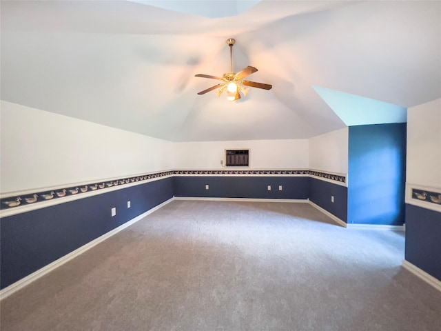 additional living space with ceiling fan, vaulted ceiling, and carpet flooring