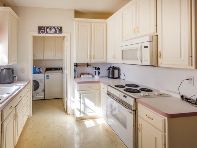 kitchen featuring sink, white appliances, and washer and dryer