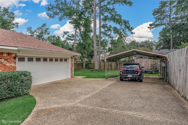 garage with a carport and a lawn