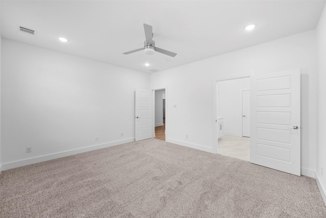 interior space with ceiling fan and light colored carpet