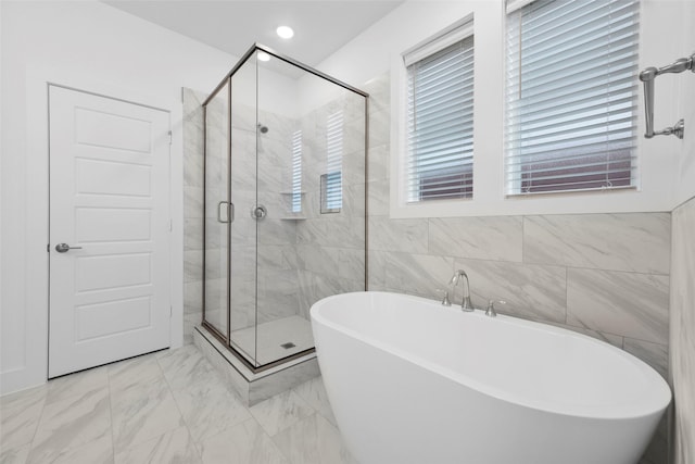 bathroom with plus walk in shower and tile walls