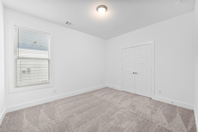 empty room with light colored carpet