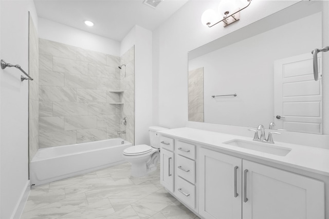 full bathroom featuring tiled shower / bath combo, toilet, and vanity