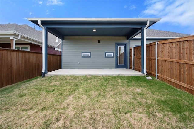 back of house featuring a patio area and a yard