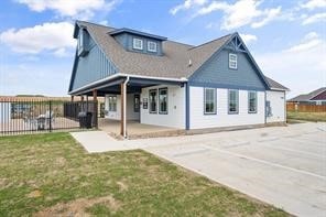 back of property with a yard and a patio area