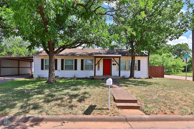 ranch-style house with a front lawn and a carport