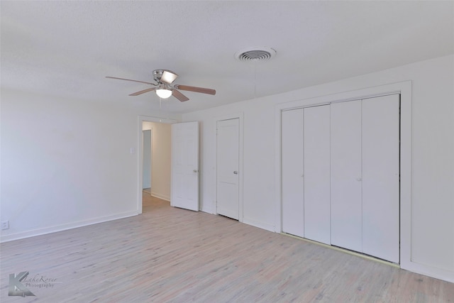 unfurnished bedroom featuring light hardwood / wood-style floors and ceiling fan