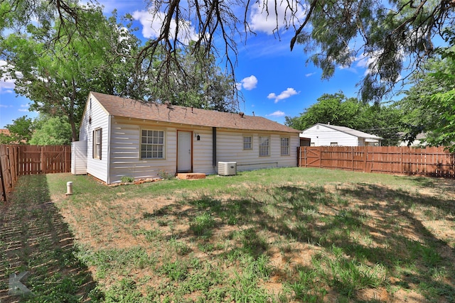 rear view of property featuring a yard