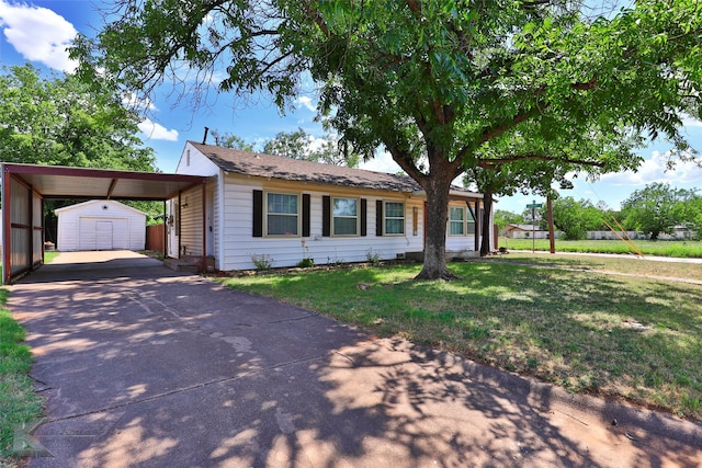 ranch-style house featuring a front yard, a carport, and a storage shed