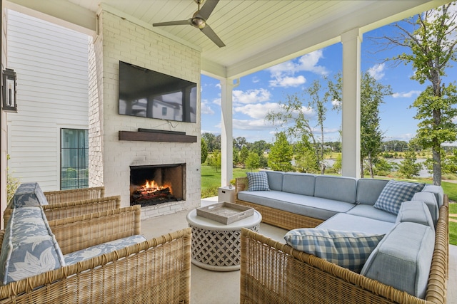 view of terrace with an outdoor living space with a fireplace and ceiling fan