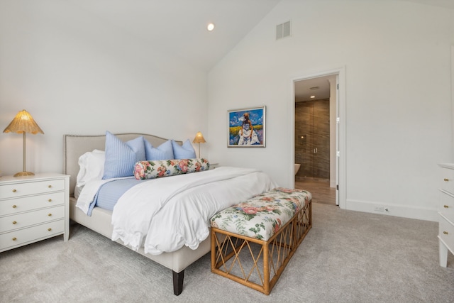 carpeted bedroom with high vaulted ceiling