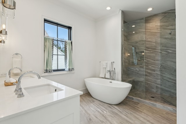 bathroom featuring a healthy amount of sunlight, vanity, separate shower and tub, and crown molding