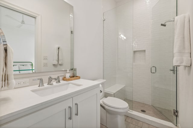 bathroom with tile floors, an enclosed shower, toilet, and vanity