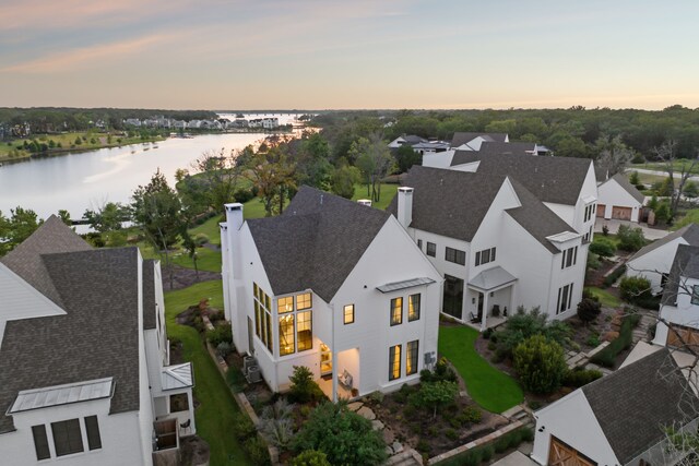 aerial view at dusk with a water view