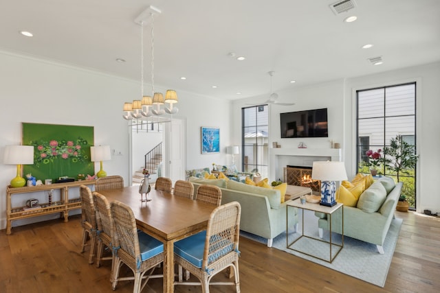 dining area with hardwood / wood-style floors, ceiling fan, and crown molding