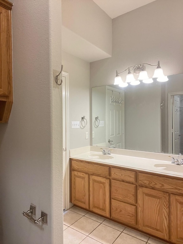 12308 Riviera Rd, Frisco, TX 75035 - bathroom featuring double vanity, a sink, and tile patterned flooring