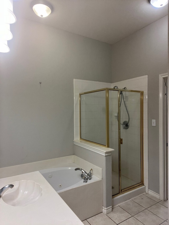 bathroom featuring tile floors, sink, and separate shower and tub