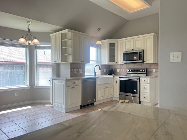 12308 Riviera Rd, Frisco, TX 75035 - kitchen with light tile patterned flooring, a sink, stainless steel appliances, tasteful backsplash, and vaulted ceiling
