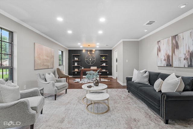 living room featuring ornamental molding, built in features, and hardwood / wood-style floors