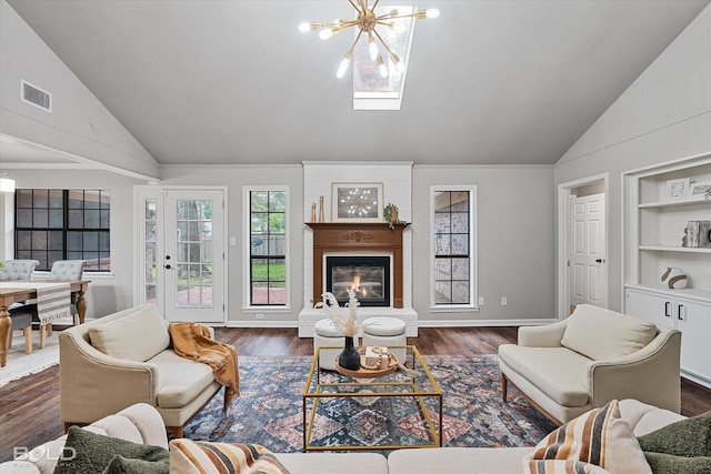 living room with an inviting chandelier, vaulted ceiling, dark hardwood / wood-style flooring, and built in features