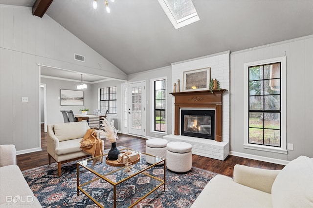 living room featuring a fireplace, dark hardwood / wood-style floors, and a healthy amount of sunlight