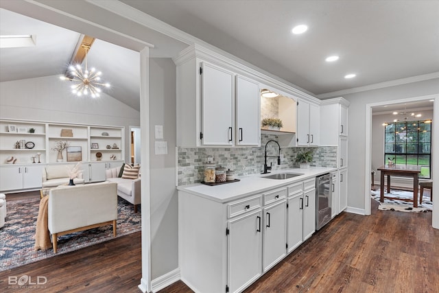 kitchen with sink, a chandelier, and white cabinets