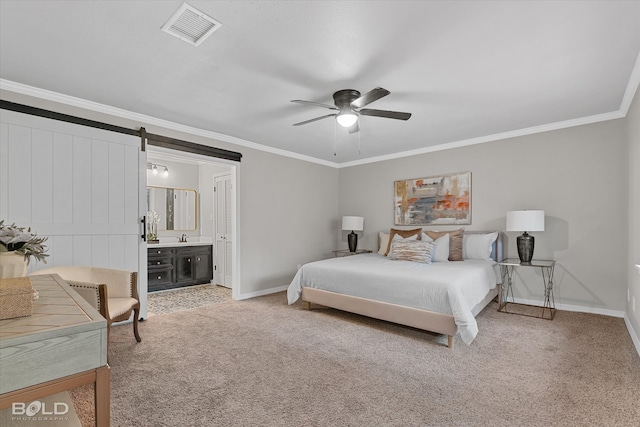 bedroom featuring ceiling fan, carpet flooring, ornamental molding, a barn door, and ensuite bathroom