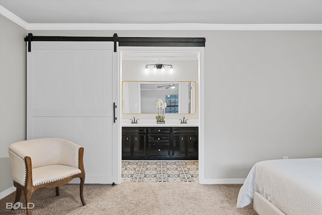 bedroom with connected bathroom, carpet, crown molding, and a barn door