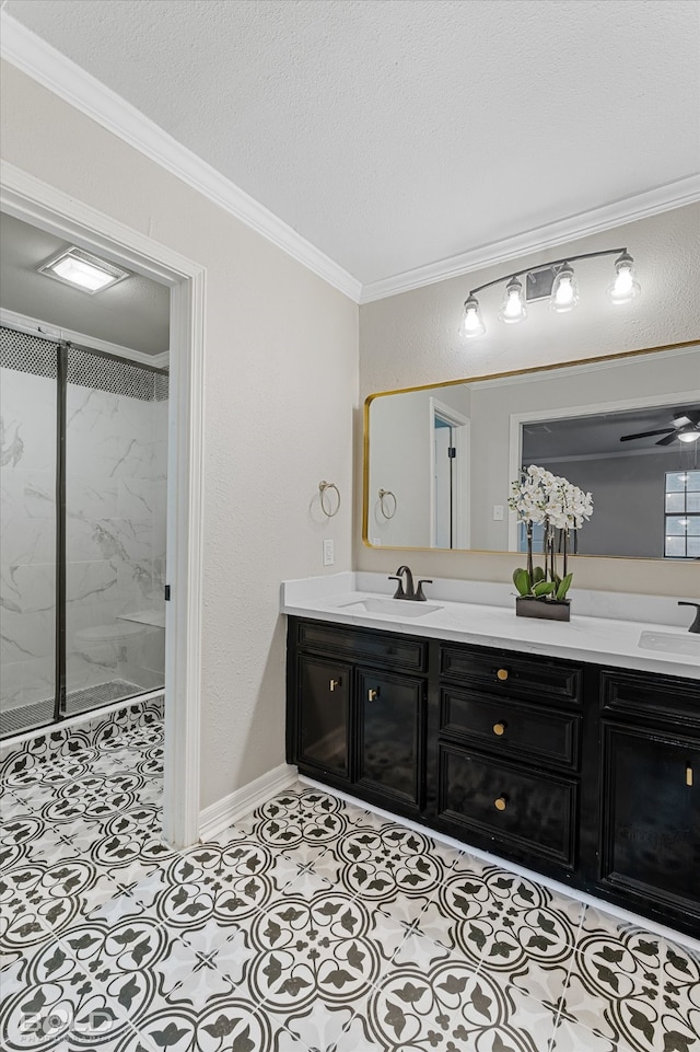 bathroom featuring ornamental molding, ceiling fan, walk in shower, and vanity