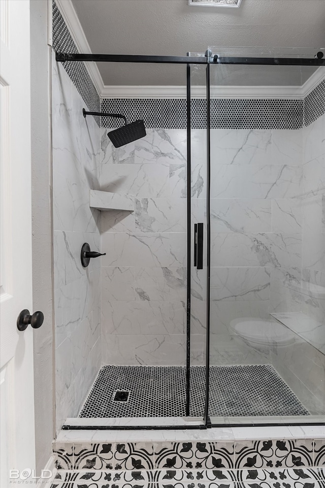 bathroom with ornamental molding and a shower with shower door