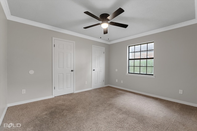 unfurnished bedroom featuring ceiling fan, crown molding, and carpet flooring